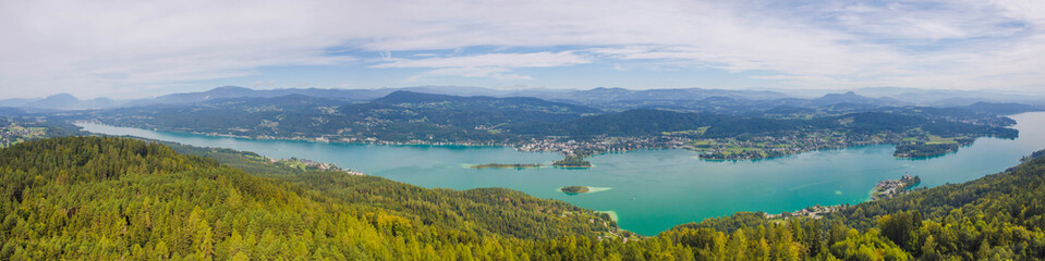 Fototapeta na wymiar Aerial view of the alpine lake Worthersee, famous tourist attraction for many water activity in Klagenfurt, Carinthia, Austria