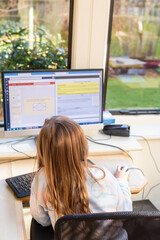 Child working at home during lockdown as children need to home school via online learning