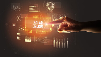 Hand touching SOLAR ENERGY inscription, new business technology concept