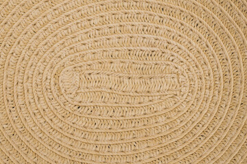 A weave pattern of a vintage paper straw hat. The texture of dried paper straw as a background