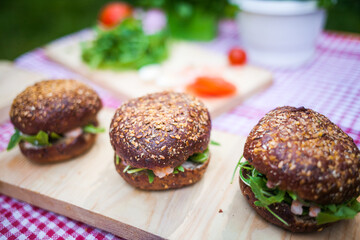 ingredients for making prawn burgers in nature. The table with the checkered tablecloth in the Park