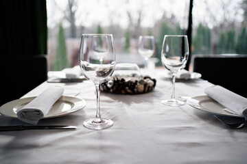 serving the table. wine glasses, plates, napkins and cutlery. design of the table for a festive dinner. service in a restaurant or cafe.