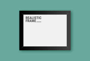 Realistic horizontal picture frame isolated on green wall background. Blank picture frame template. Empty photo frame mockup.