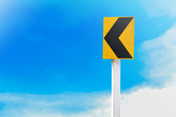 Yellow Chevron traffic sign. Reflective sign indicate the way to turn left on the curve ahead.