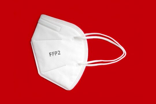 Side view of FFP 2 n95 protective face mask isolated on red background. 