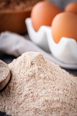 fresh natural buckwheat flour on a dark stone background culinary concept