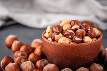 fresh natural hazelnuts on a dark stone background
