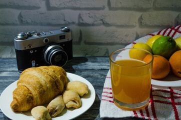 Still life with fresh fruits and glass of juice on the wooden background
