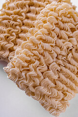 instant egg noodles on a white acrylic background