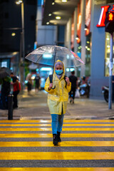Young teenager walking during raining season with available light.