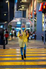 Young teenager walking during raining season with available light.