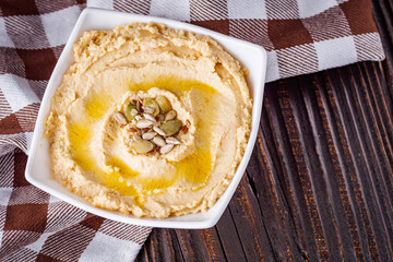 traditional turkish hummus on a dark wooden rustic background