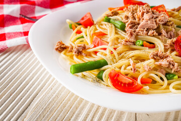 delicious traditional Italian pasta with tuna on a white rustic wooden background