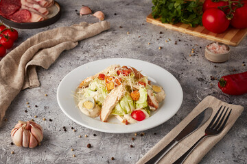 Caesar salad with chicken, textured background