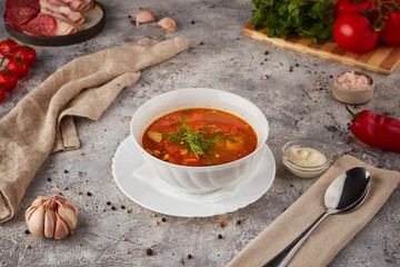 Hot soup with meat and vegetables, textured background