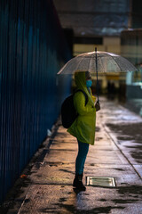 Young teenager walking during raining season with available light.