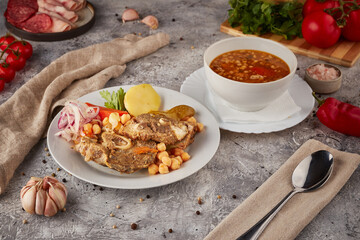 Braised pork and beef with vegetables and spices, textured background