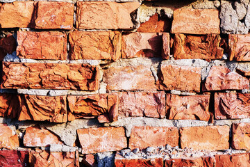Obraz premium fragment of old crumbling brick wall shot close-up with backlight
