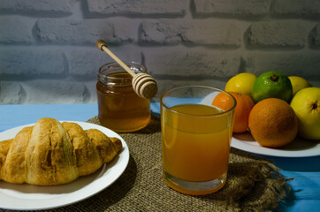 Still life with fresh fruits and glass of juice on the wooden background