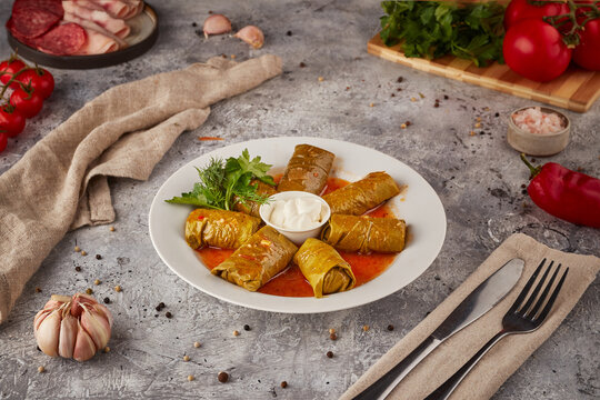 Stuffed roll with rice and stew, textured background