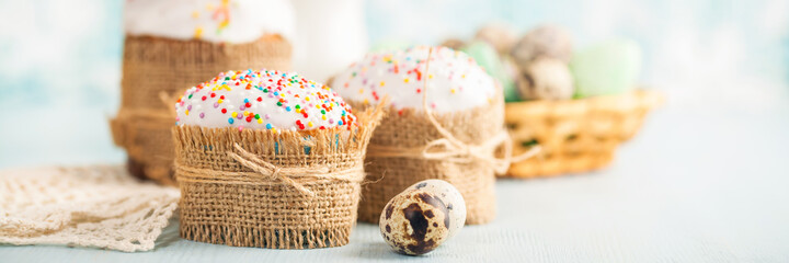 Fototapeta na wymiar Easter orthodox sweet cakes, kulich and colorful quail eggs . Holidays Easter concept. Banner