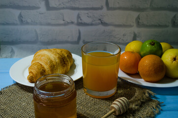 Still life with fresh fruits and glass of juice on the wooden background
