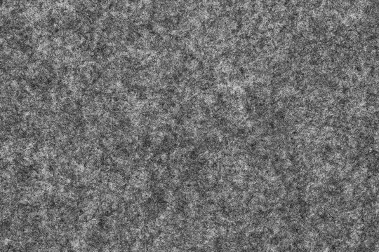 Sample of felt in dark grey color. A texture of felted fabric made of  pressed fibres