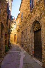 A street of historic stone buildings in the village of Montemerano near Manciano in Grosseto province, Tuscany, Italy
