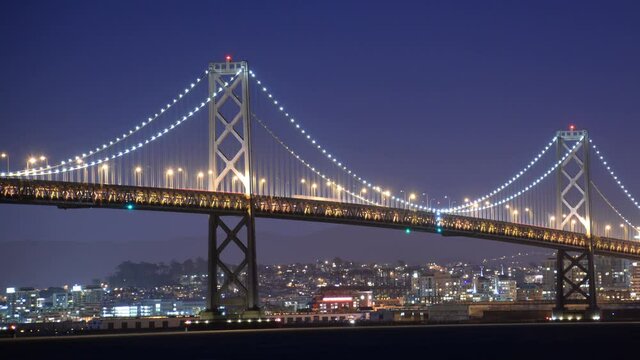San Francisco Bay Bridge from Treasure Island Time Lapse Night Traffic Pan Right California USA
