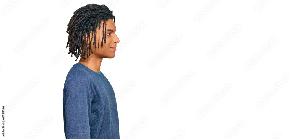 Wall mural Young african american man wearing casual winter sweater looking to side, relax profile pose with natural face and confident smile. - Wall murals