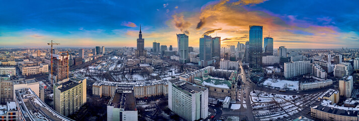 Fototapeta na wymiar Beautiful panoramic aerial drone view on All Saints Church - Roman Catholic church located at Grzybowski Square, Warsaw City Skyscrapers, PKiN, and Varso Tower under construction. Warsaw, Poland