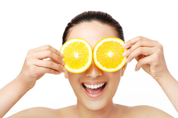 Oriental beauty with two slices of orange to cover the eyes