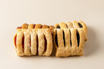 Variety of Homemade Puff Pastry Buns with Jam on Pink Napkin Yellow Background Horizontal