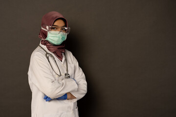 Researcher wearing protection with grey background.