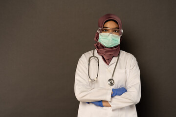 Researcher wearing protection with grey background.