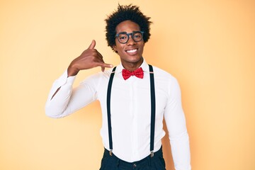Handsome african american man with afro hair wearing hipster elegant look smiling doing phone...