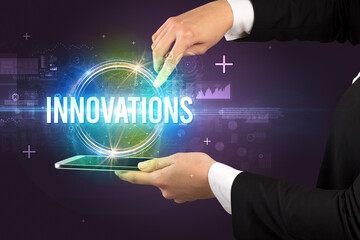 Close-up of a touchscreen with INNOVATIONS inscription, new technology concept