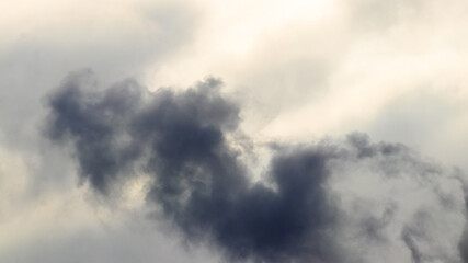 Dark thick smoke in the evening sky, air pollution