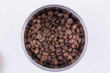 roasted coffee beans in a round jar