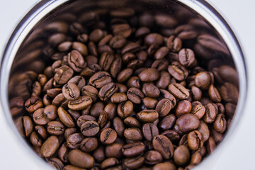 roasted coffee beans in a round jar