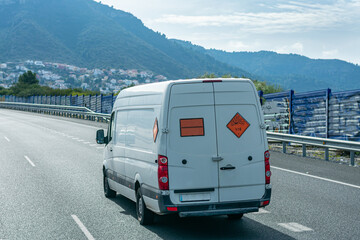 Van transporting explosives, with orange panel and danger labels for expolsion. © M. Perfectti