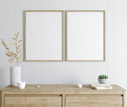 Mockup poster frame in modern interior with white wall and wooden console, home interior with plant, 3d rendering