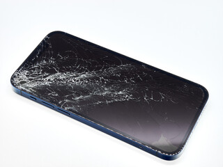 Photo of blue smartphone with broken damaged display. Modern smartphone with damaged glass screen...