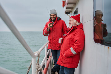 Colleagues discussing something during tea break at the deck