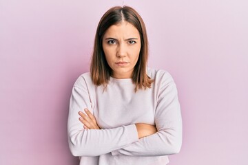 Young beautiful woman wearing casual clothes skeptic and nervous, disapproving expression on face with crossed arms. negative person.