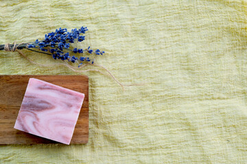 Spa cosmetic treatment concept. Handmade soap and a bouquet of lavender on a yellow background. copyspase flatlay. 
