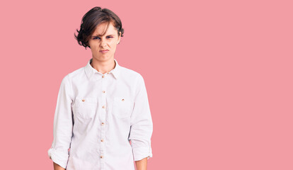 Beautiful young woman with short hair wearing elegant white shirt skeptic and nervous, frowning...