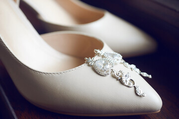 elegant leather shoes and luxurious earrings of the bride. details of the preparation for the wedding