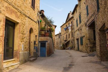 Fototapeta na wymiar Historic residential buildings in the medieval village of San Lorenzo a Merse near Monticiano in Siena Province, Tuscany, Italy 