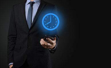 Businessman hand holds the icon of hours clock with arrow. Rapid execution of the work.Business...